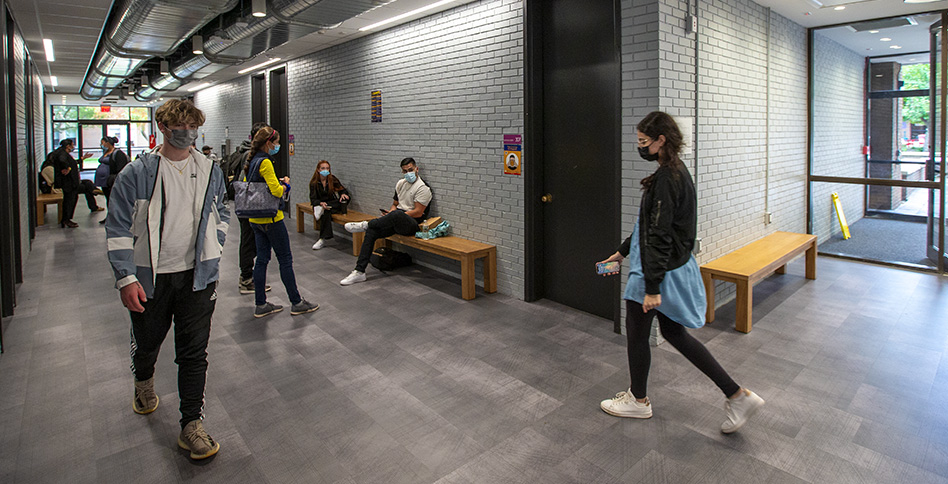 Masked students walking around hallway