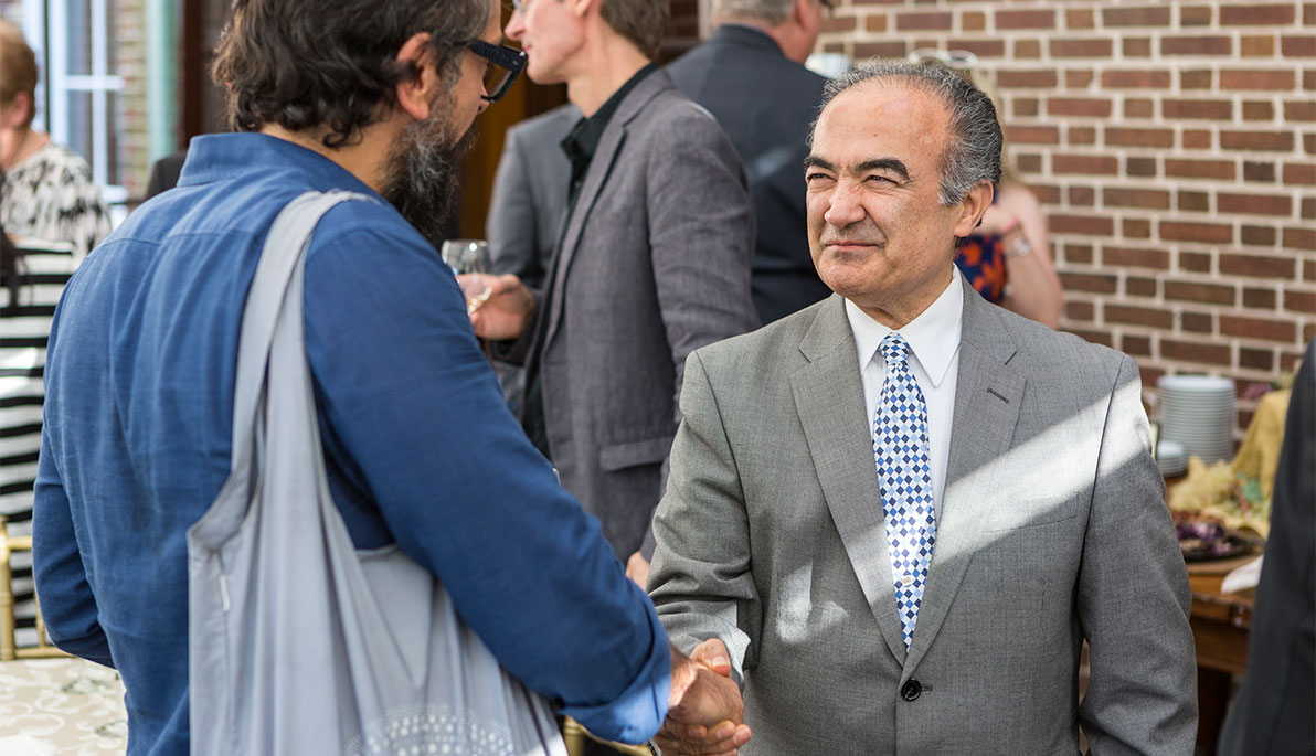 Provost Shoureshi talks with a faculty member at the welcome reception.