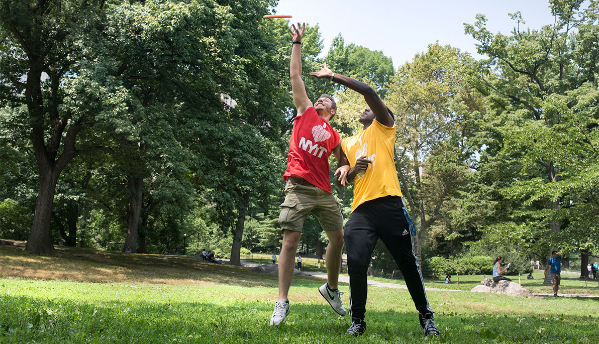 NYIT students playing frisbee
