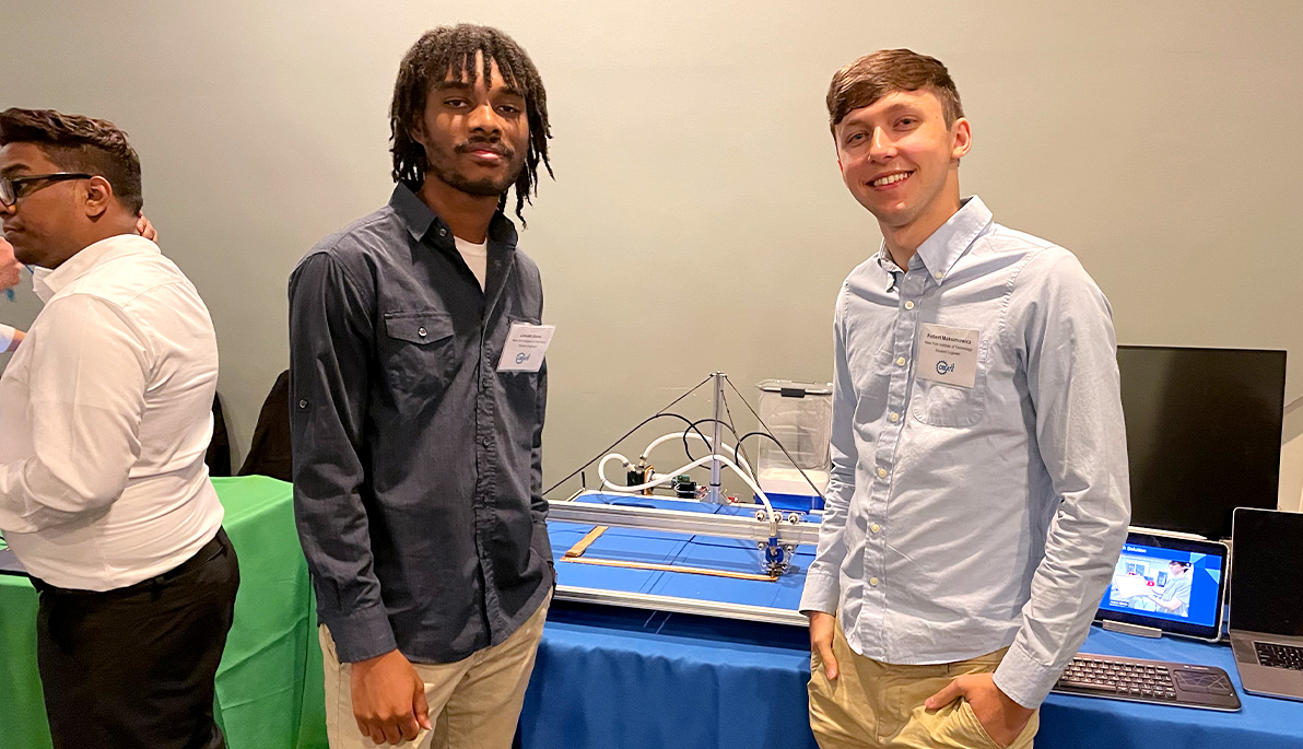 Two New York Tech students at the symposium