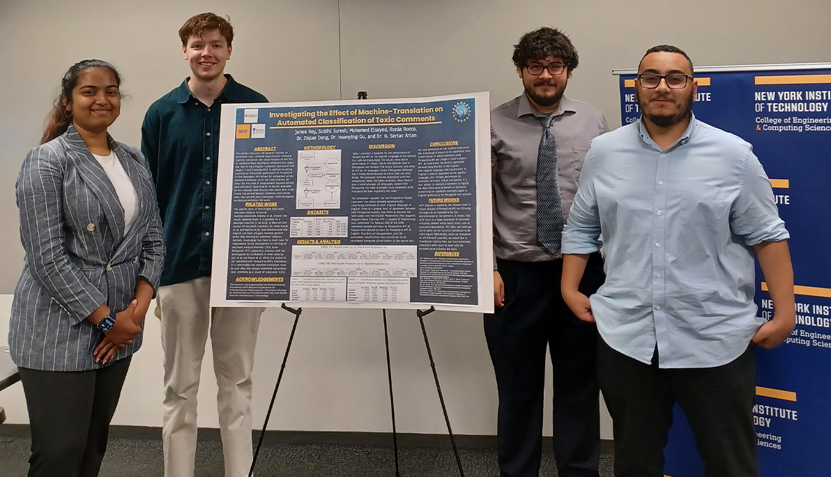 Students in front of their poster at the REU final presentations.