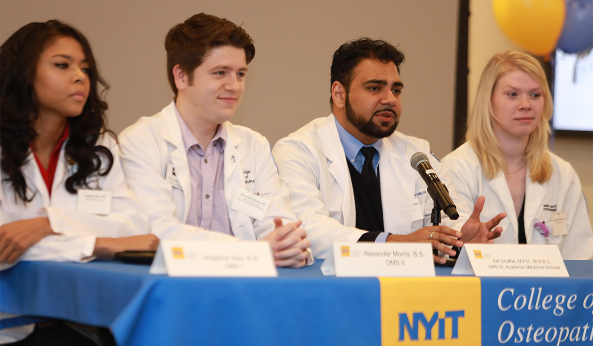 NYITCOM students sitting together on a panel stage. 