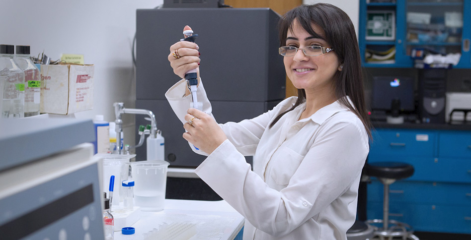 NYITCOM student performing an experiment