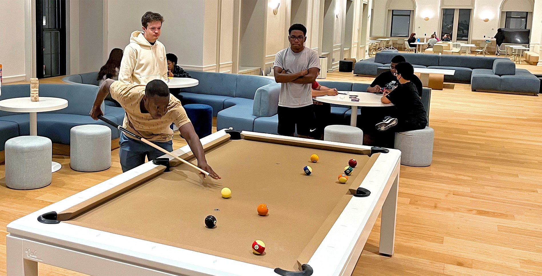 Students playing pool inside 525 Lexington building lounge