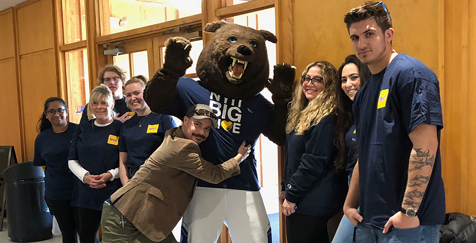 Group of students hugging Roary, the New York Tech bear mascot