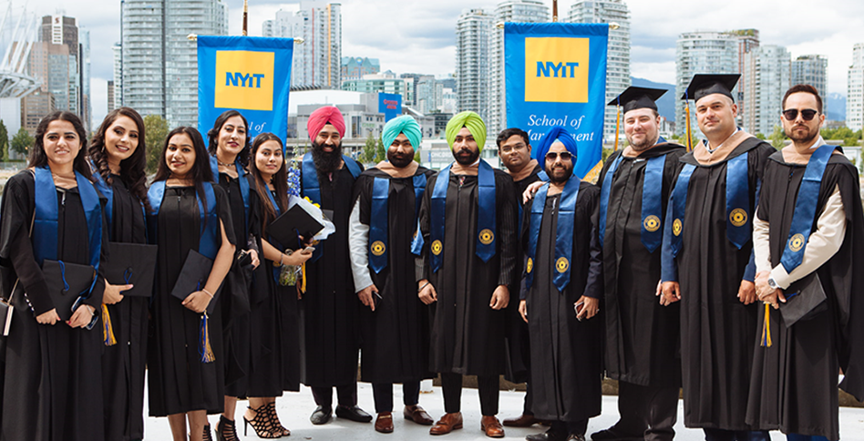 Group photo of students in graduation gowns in front of city skyline