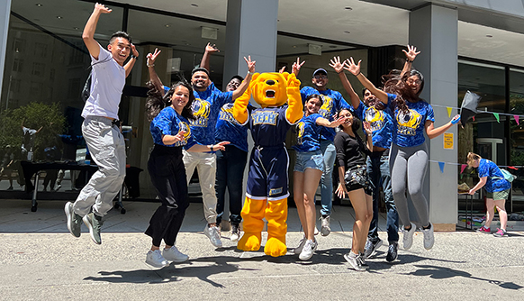 Students and Roary cheering outside of NYC campus.
