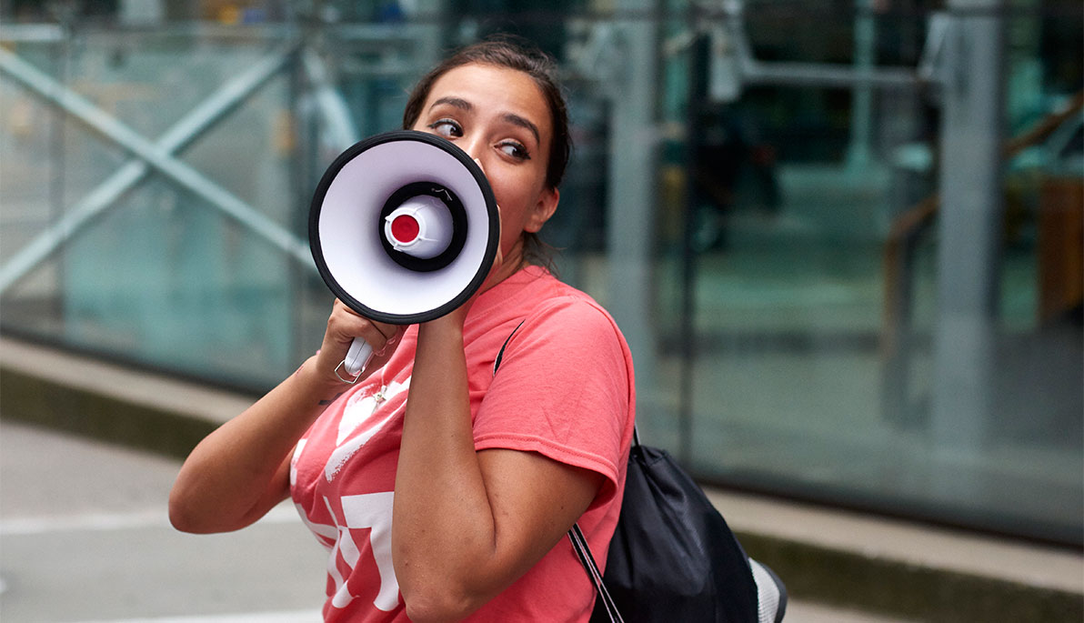 NYIT student speaking into a megaphone
