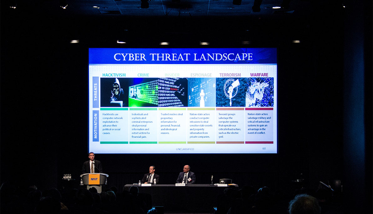 Guest speakers presenting on stage at the Cybersecurity Conference.