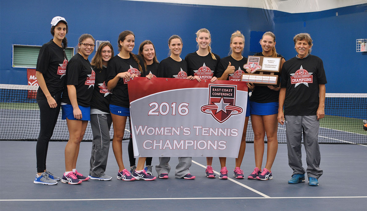 The women’s tennis team holding a banner that reads “2016 Women’s Tennis Champions”