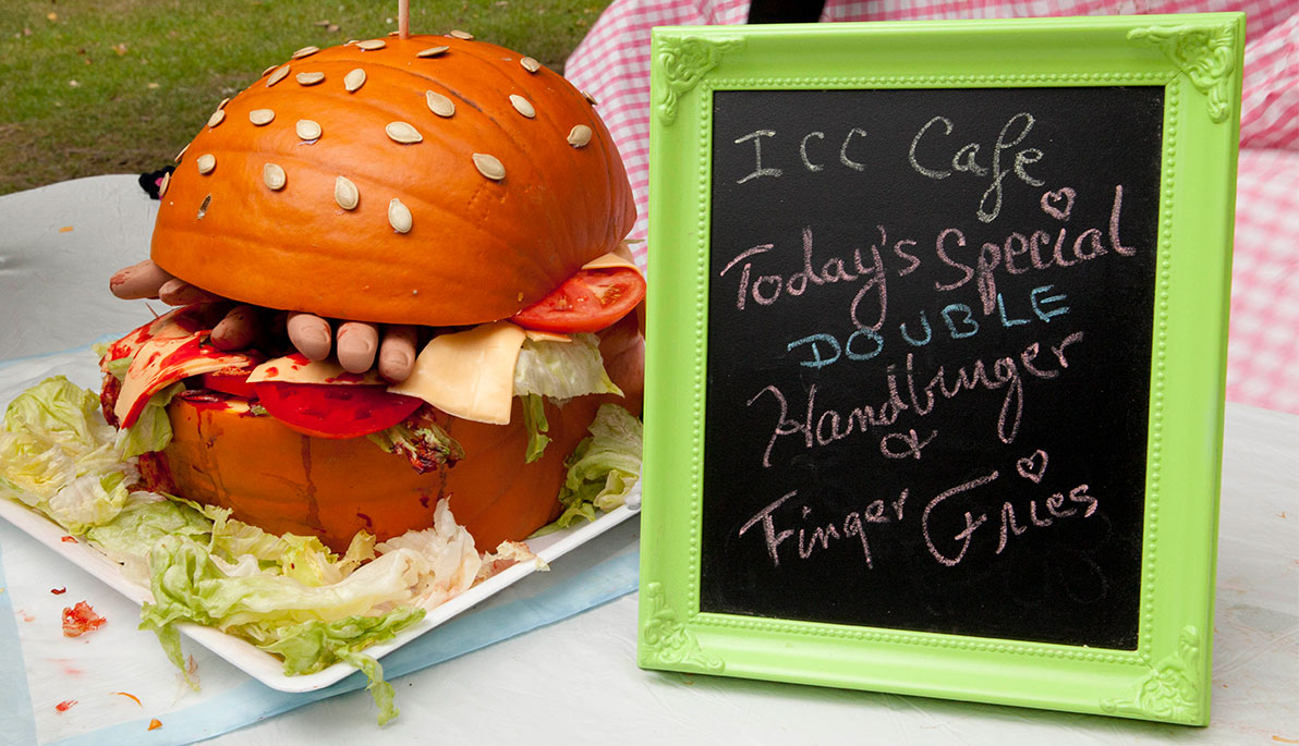 Pumpkin carved into a "hand" burger and "finger" fries.