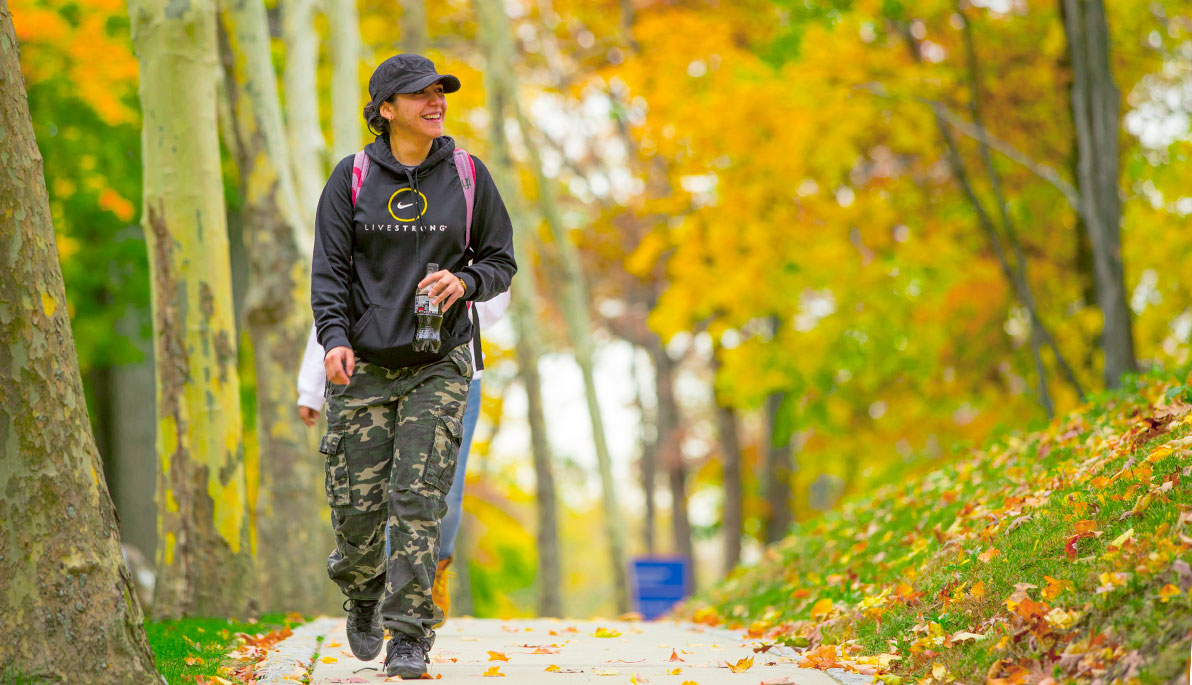 Female veteran walking in the woods.