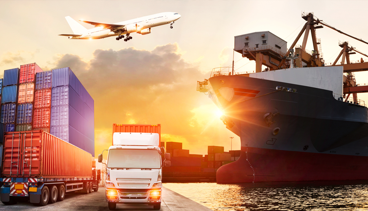 A truck at a port, shipping containers, a ship, and airplane flying overhead.