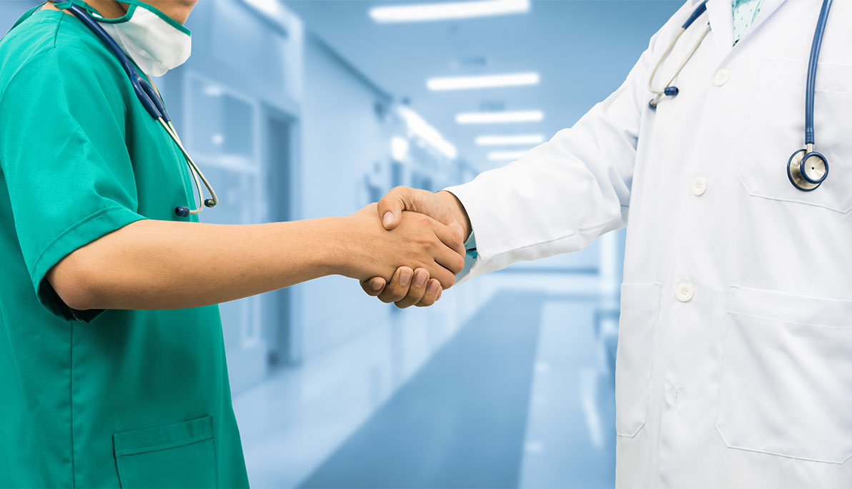 Two doctors shaking hands.