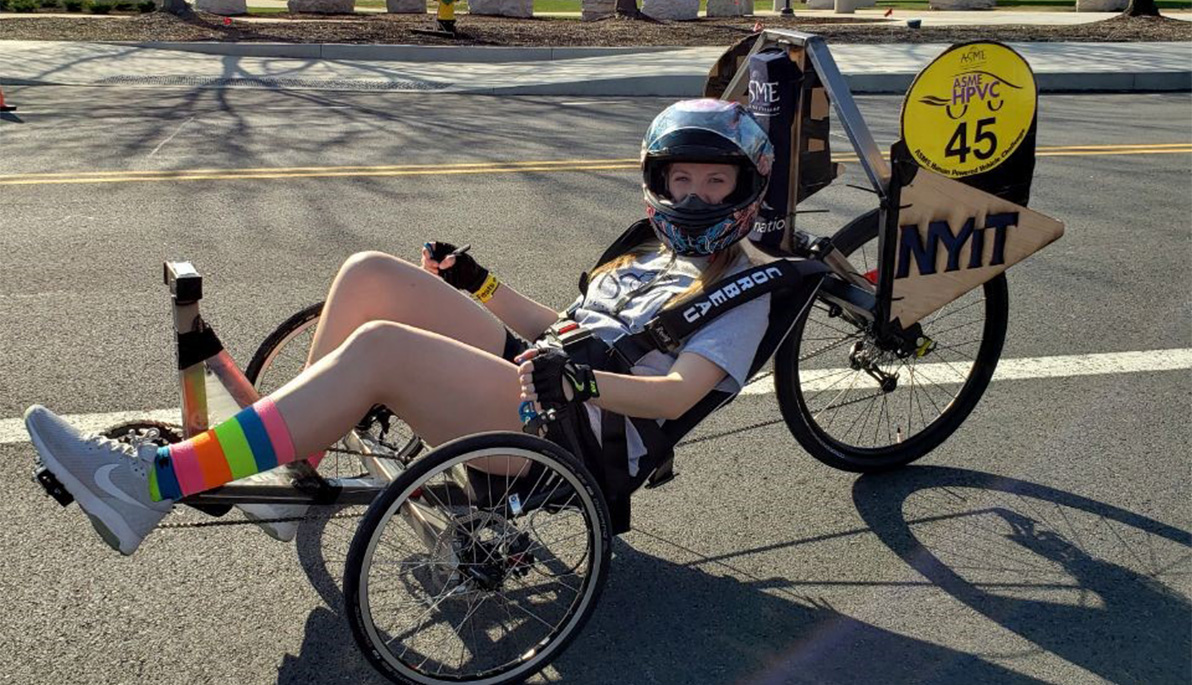 NYIT student Alexandra Kawecki riding the human powered vehicle