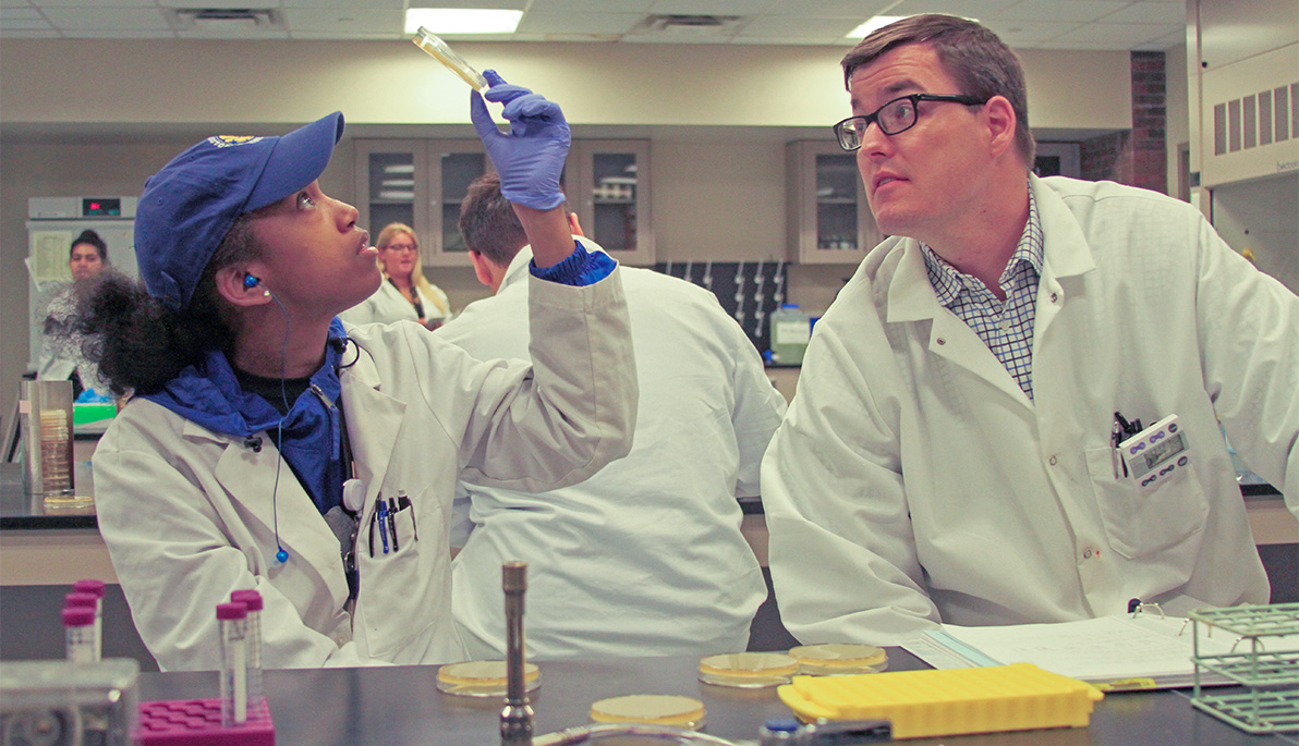 NYIT Assistant Professor Bryan Gibb with an NYIT student in the lab.