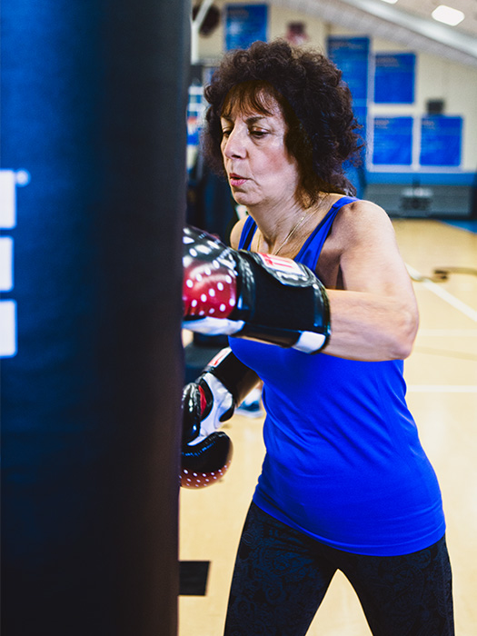 A woman exercising with a punching bag
