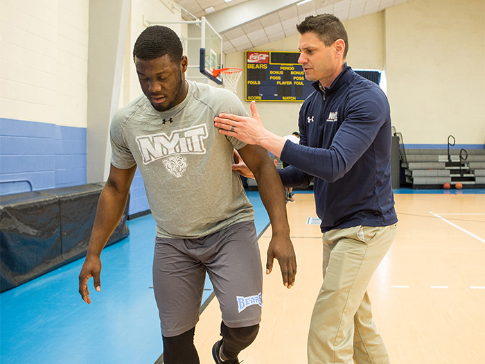 Eric Greenberg provides physical therapy services to a student-athlete