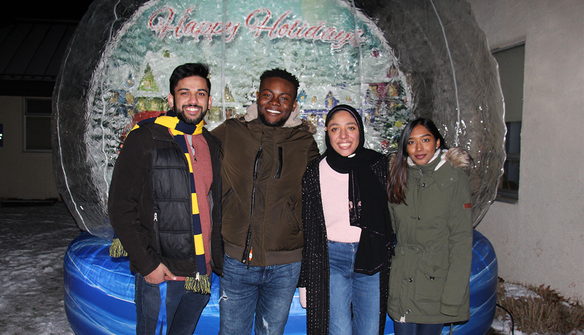 New York Tech students in front of a blow up snow globe