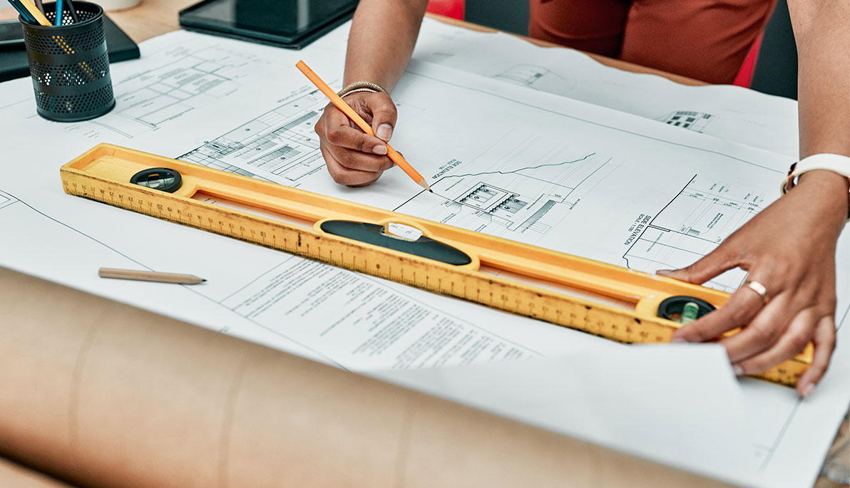Close-up abstract image of a student sketching out an architectural plan