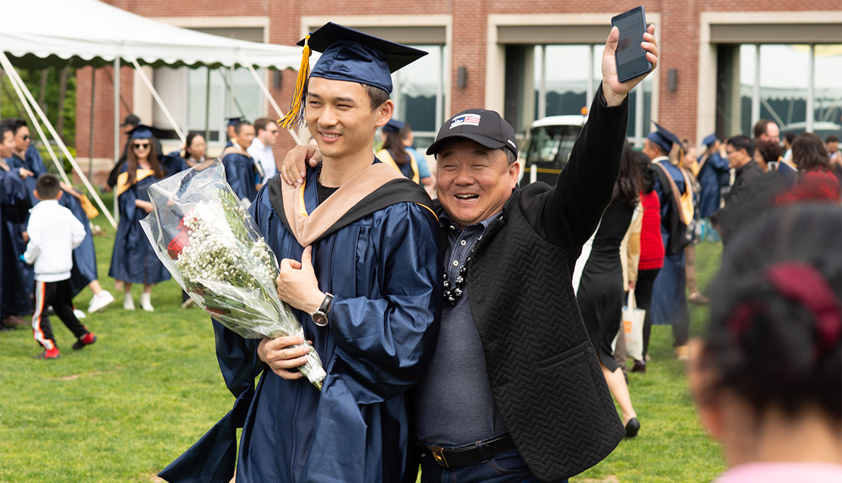 New York Tech student at graduation with his father