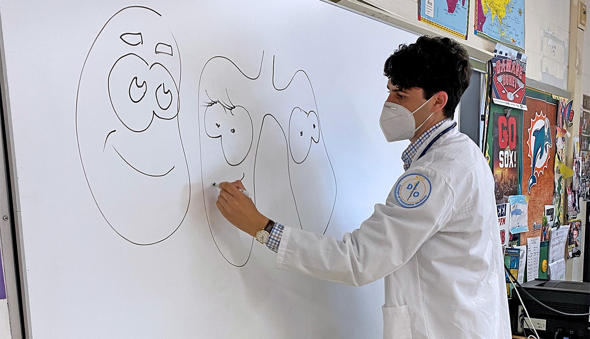 College of Osteopathic Medicine student Jacob Salner at a whiteboard.