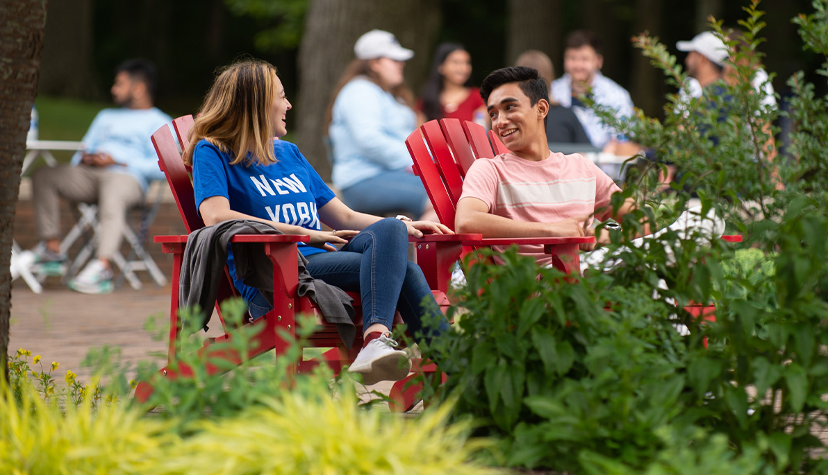 Students sitting in a parklet on the Long Island campus.