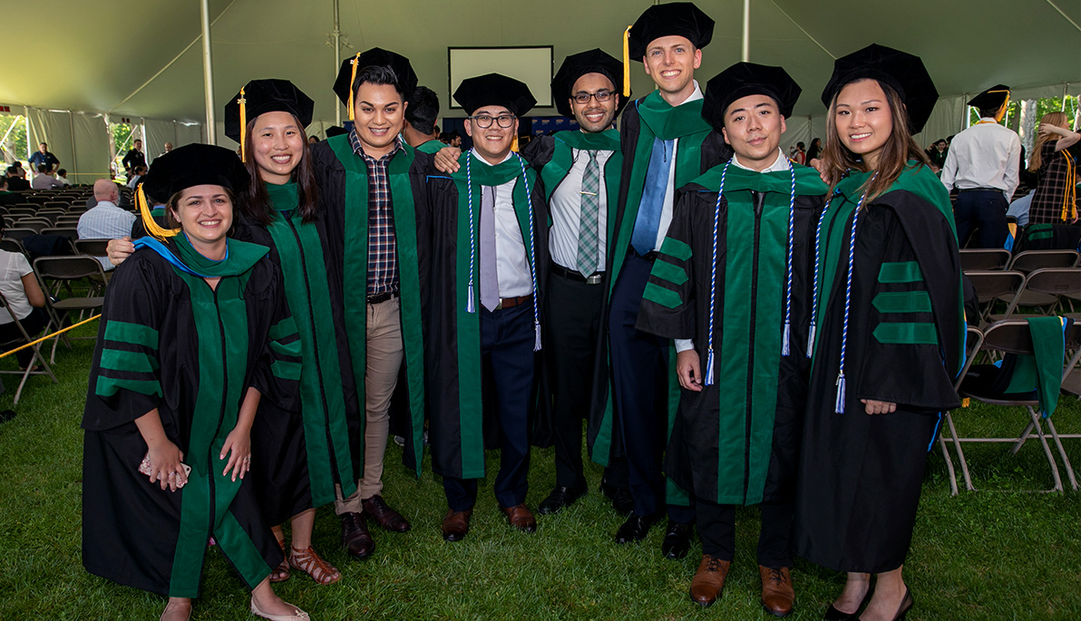 Group of NYITCOM graduates on the Long Island campus.