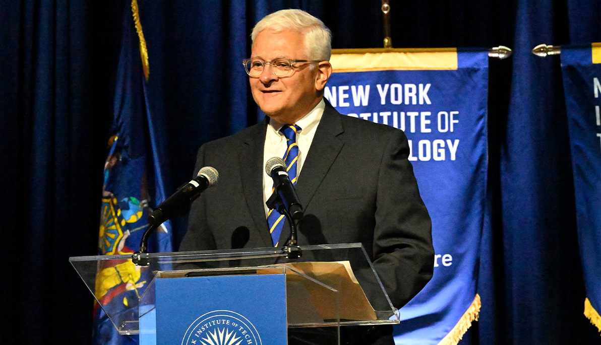 New York Tech President Hank Foley speaking at the podium.
