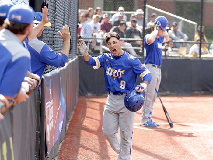 EJ Cumbo returns to the dugout with enthusiasm while highfiving another player after delivering a game-tying homer in the NCAA Regional opener