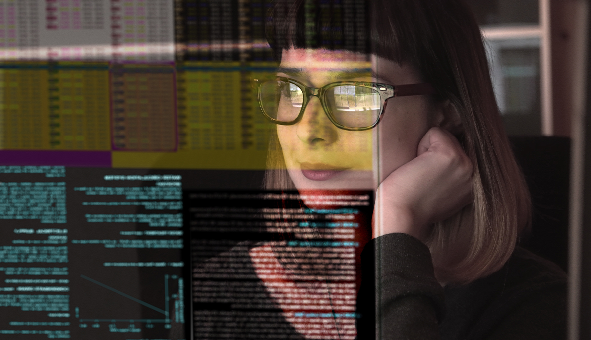 Woman concentrating on a see through screen carrying a variety of data.