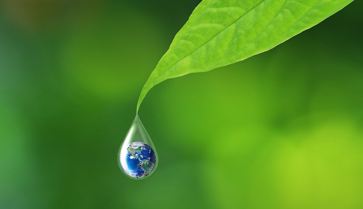 Drop of water with the earth in it falling off a leaf