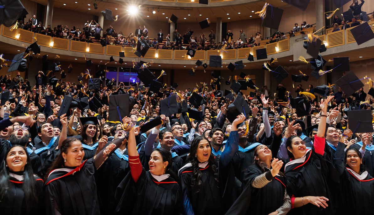Graduates throwing their caps in the air.