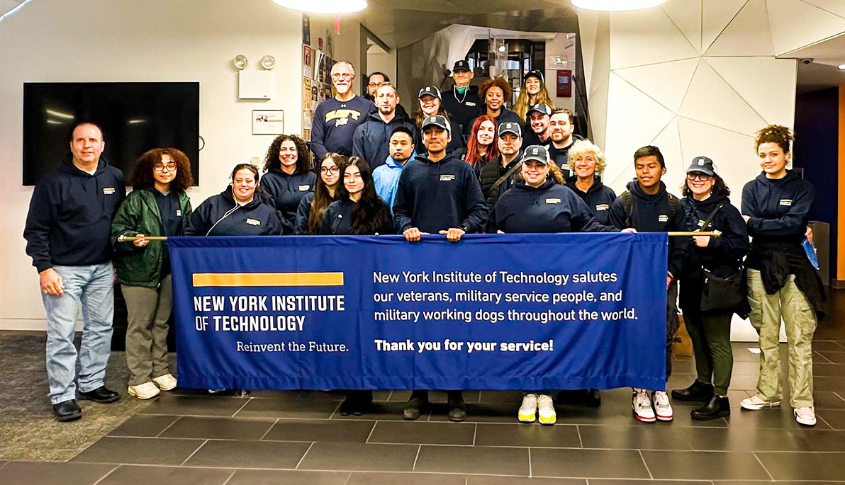 Group of New York Tech student veterans, faculty, and staff in front of a New York Tech banner