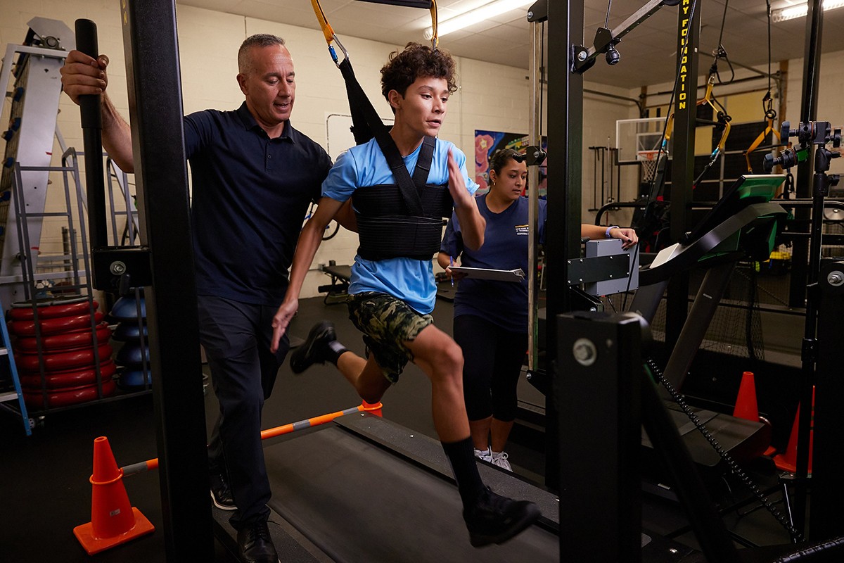 boy running on treadmill with trainers