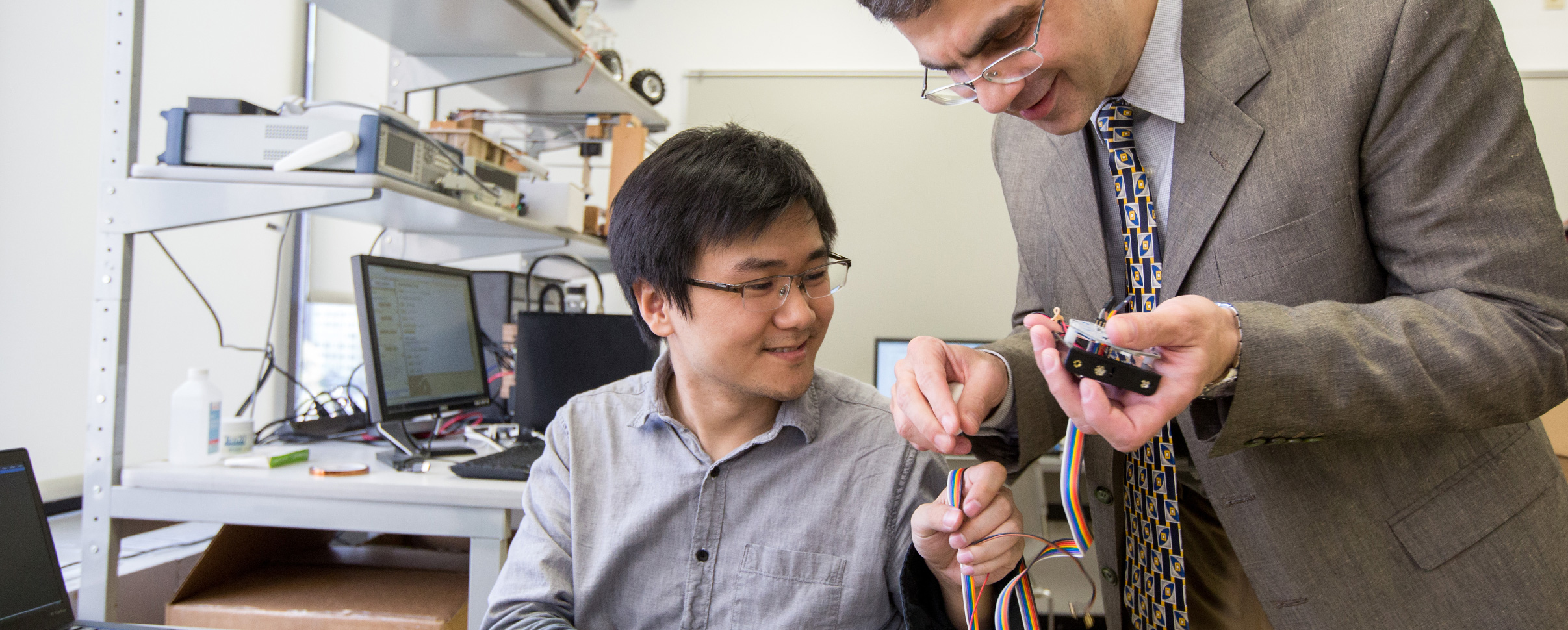 student and professor working on circuits