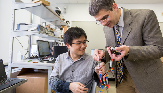 student and professor working on circuits