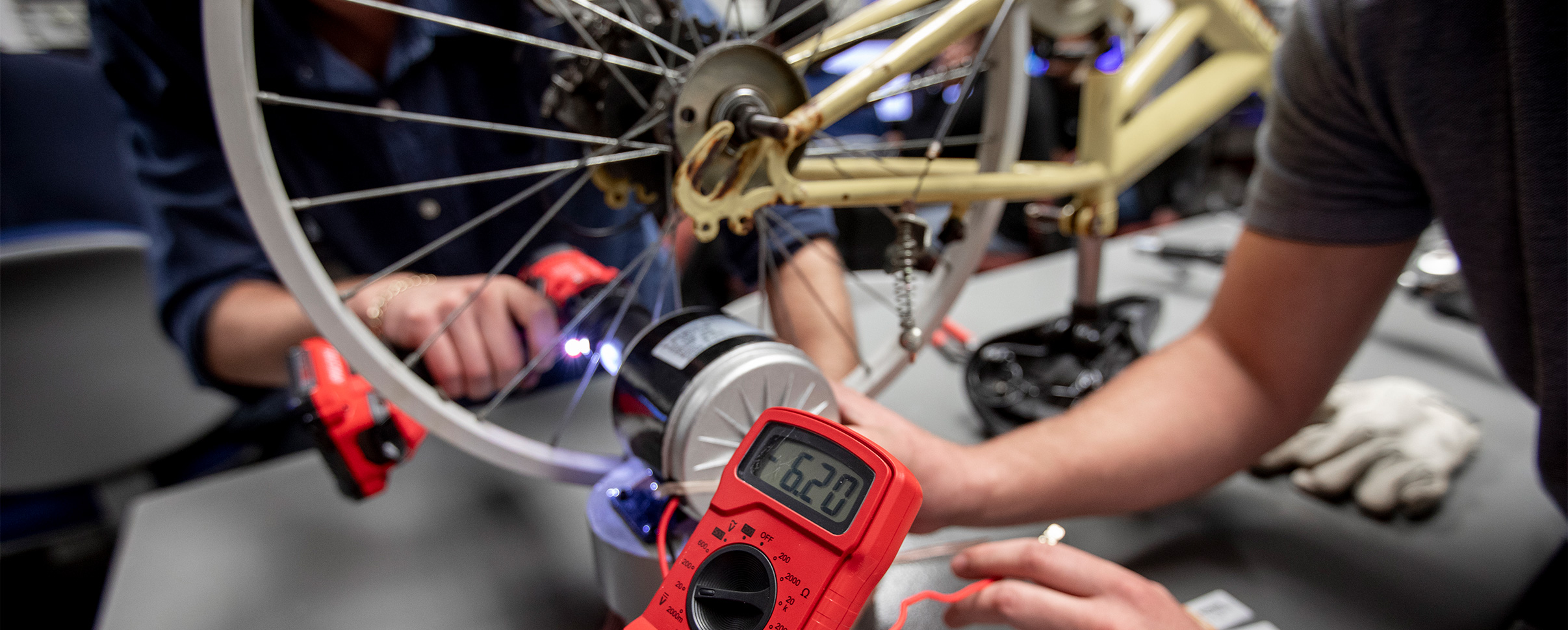 students working on electric motor for bicycle