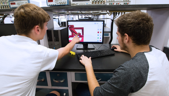 Two students looking at a graphics program