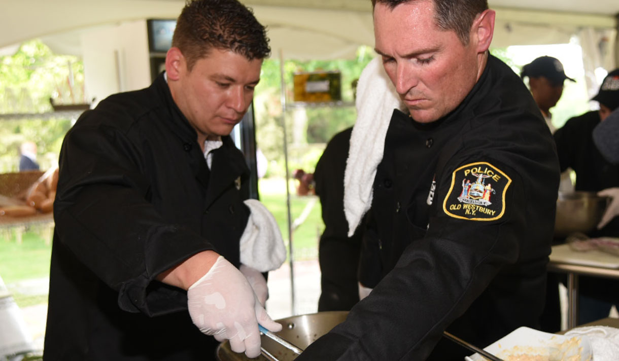 Iron Chef contestants from the Old Westbury Police Department prepare a meal.
