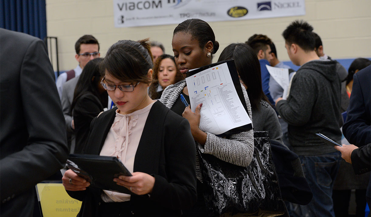 Students in professional attire gathered in a career fair.