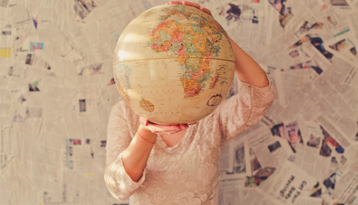 Person holding a globe