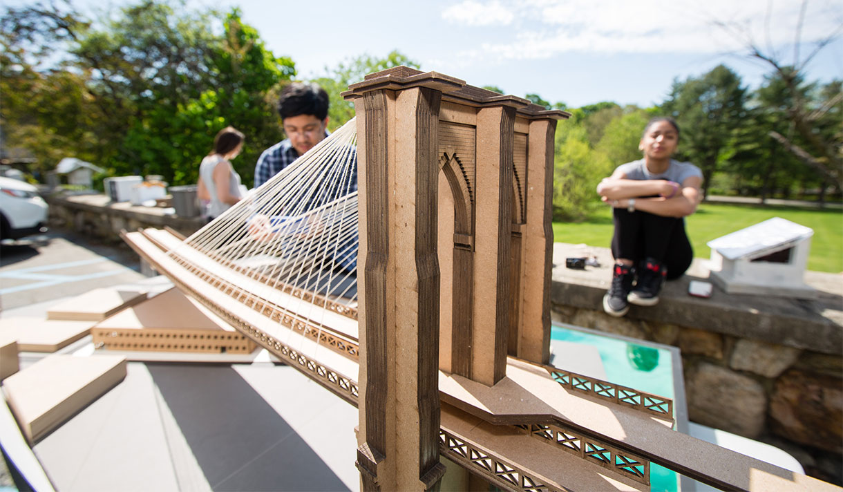 Architecture students constructing a replica of the Brooklyn Bridge