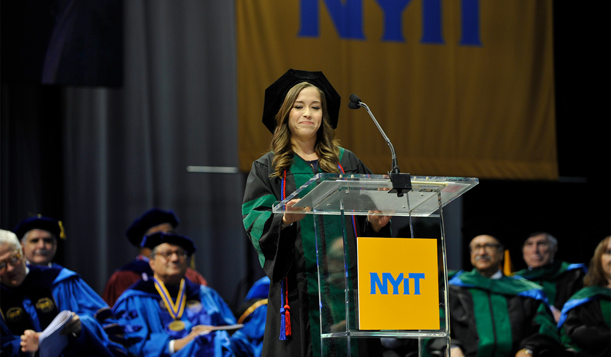 Student speaking at the 2018 NYITCOM Hooding Ceremony & Commencement