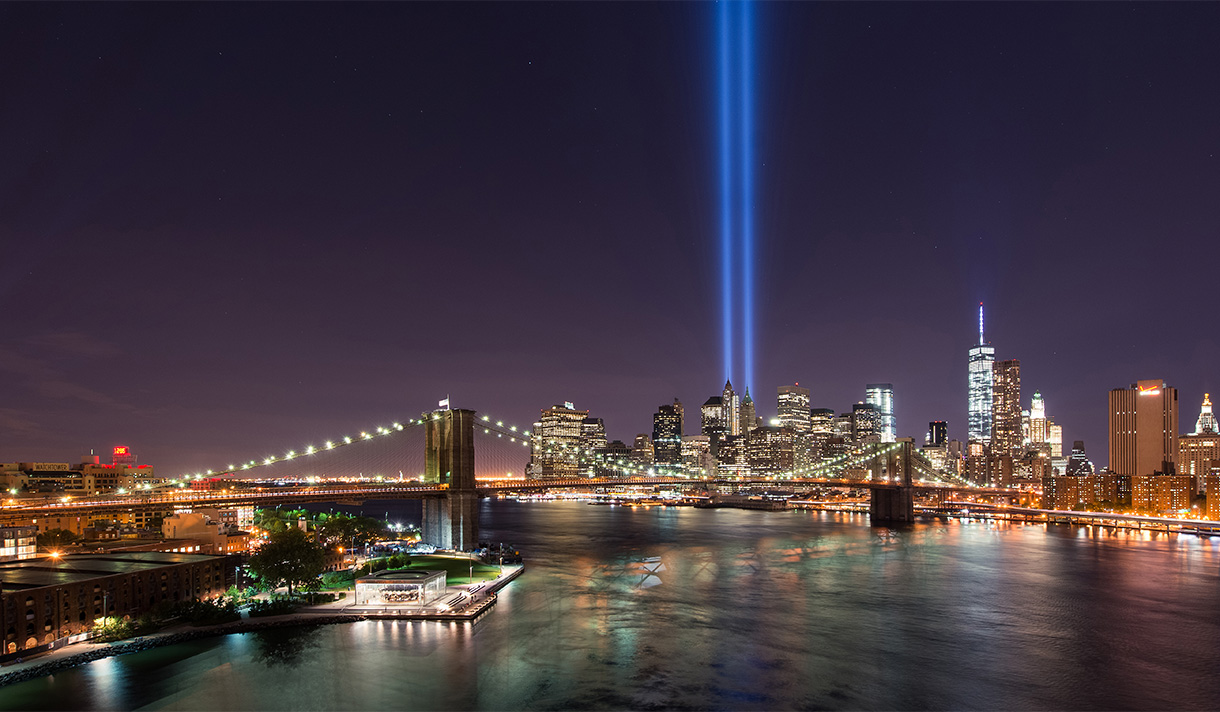 Nighttime photo of downtown NYC skyline with 9/11 Tribute in Light