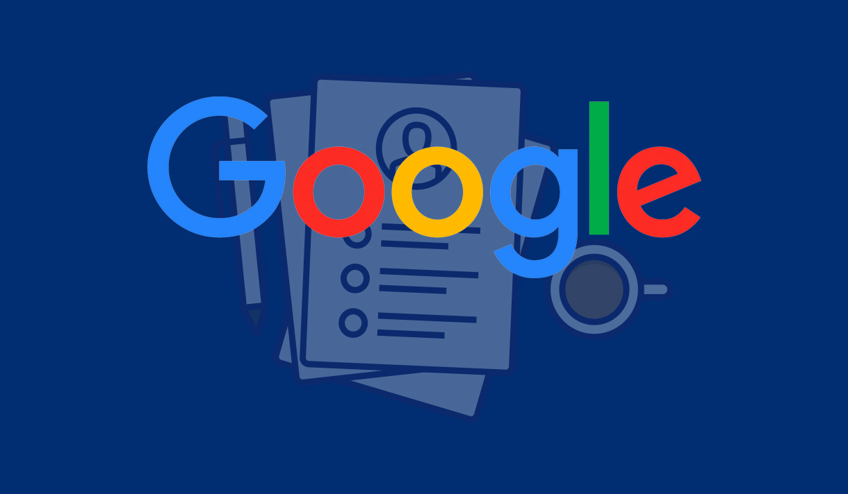 Google logo on top of a desk that has a pen, paper, and coffee