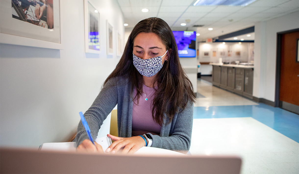 Masked student at a desk