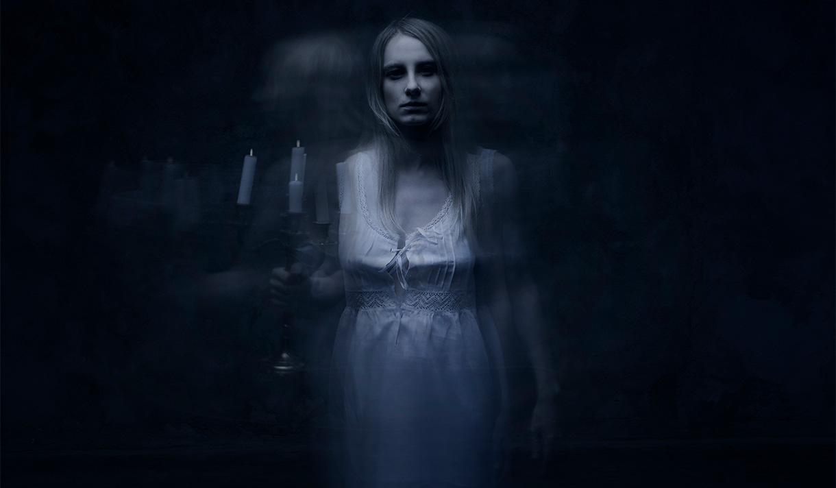 Ghostly woman surrounded by dark ambient lighting
