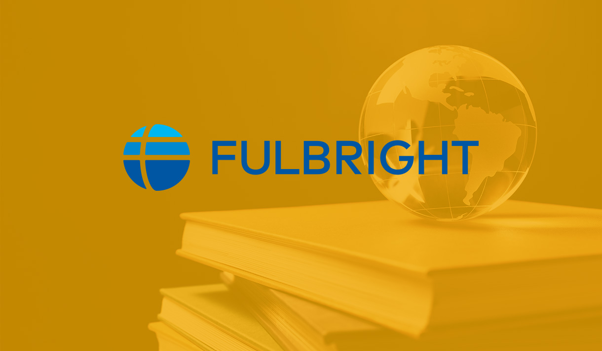 Fullbright logo overlaying an orange tinted image of a globe on top of books
