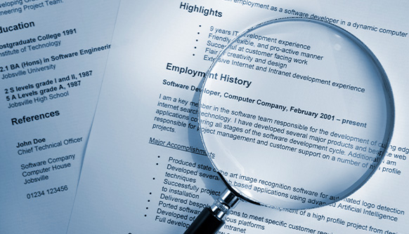 a magnifying glass on a resume